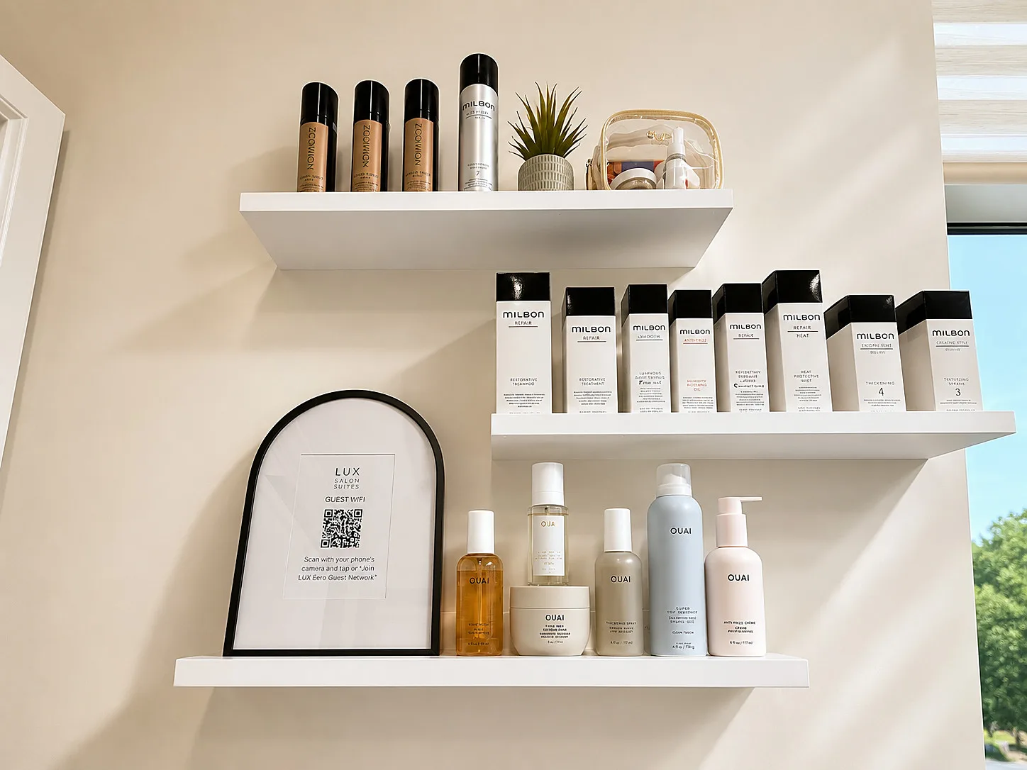 Curated product shelves — Milbon and OUAI haircare